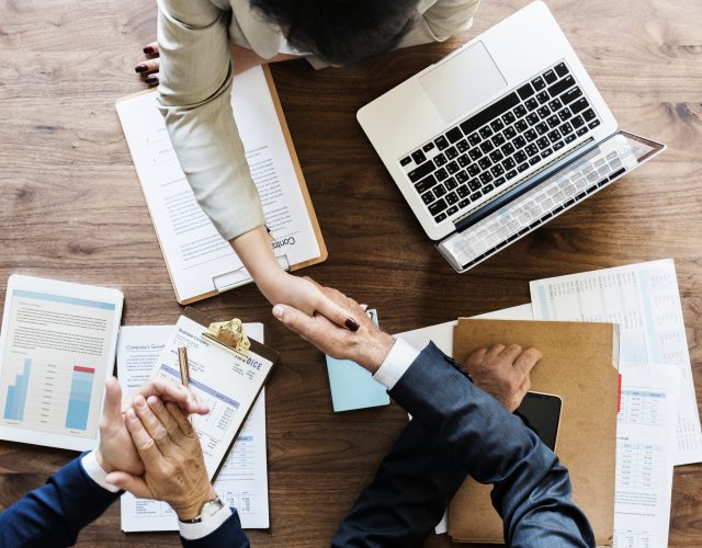 Business people shaking hands together